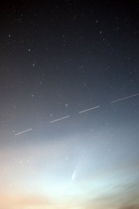 An image that shows the comet NEOWISE with the International Space Station and the Big Dipper in the background